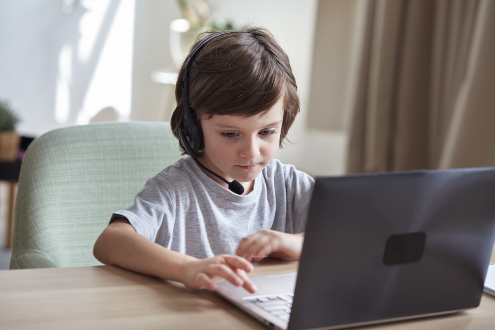 Boy with headset on computer