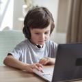 Boy with headset on computer